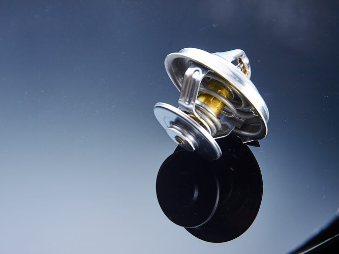 thermostat for engine cooling system of the car is wet to a dark glass