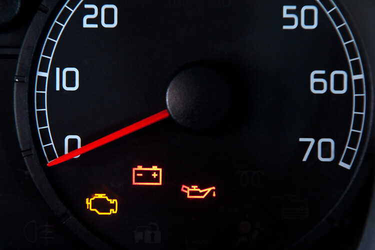 Close up of car dashboard with check engine light