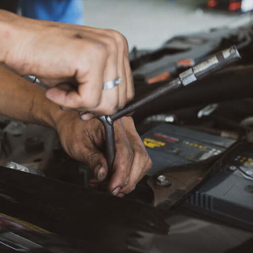 Mechanics use a wrench tool for changing car batteries. Fixing the car concept.Soft focus