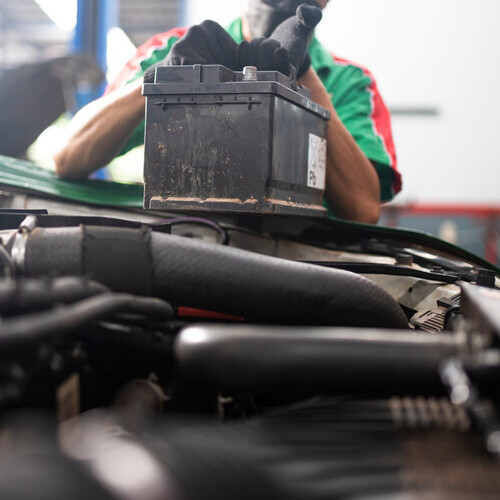mechanic changing a car battery