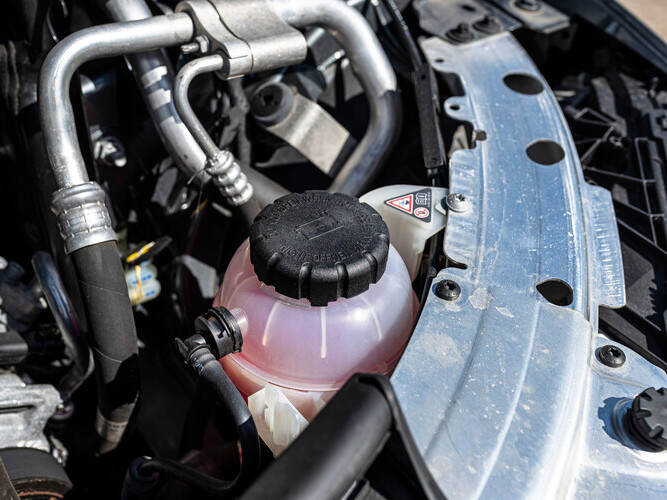 coolant reservoir next to an engine
