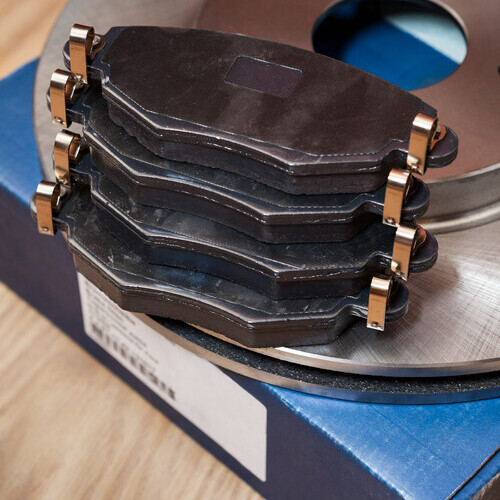 Set of brake pads for front and rear wheel with brake disks with carton box, close up